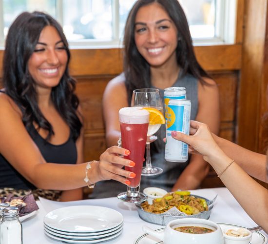 Women enjoying drinks at happy hour at Finnegan's