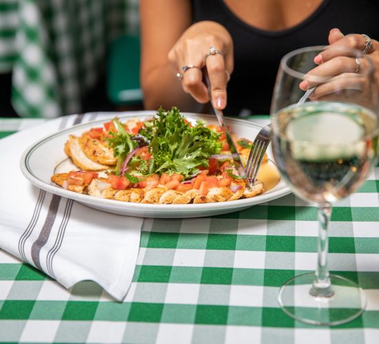 A woman eating Salad at Finnegan's