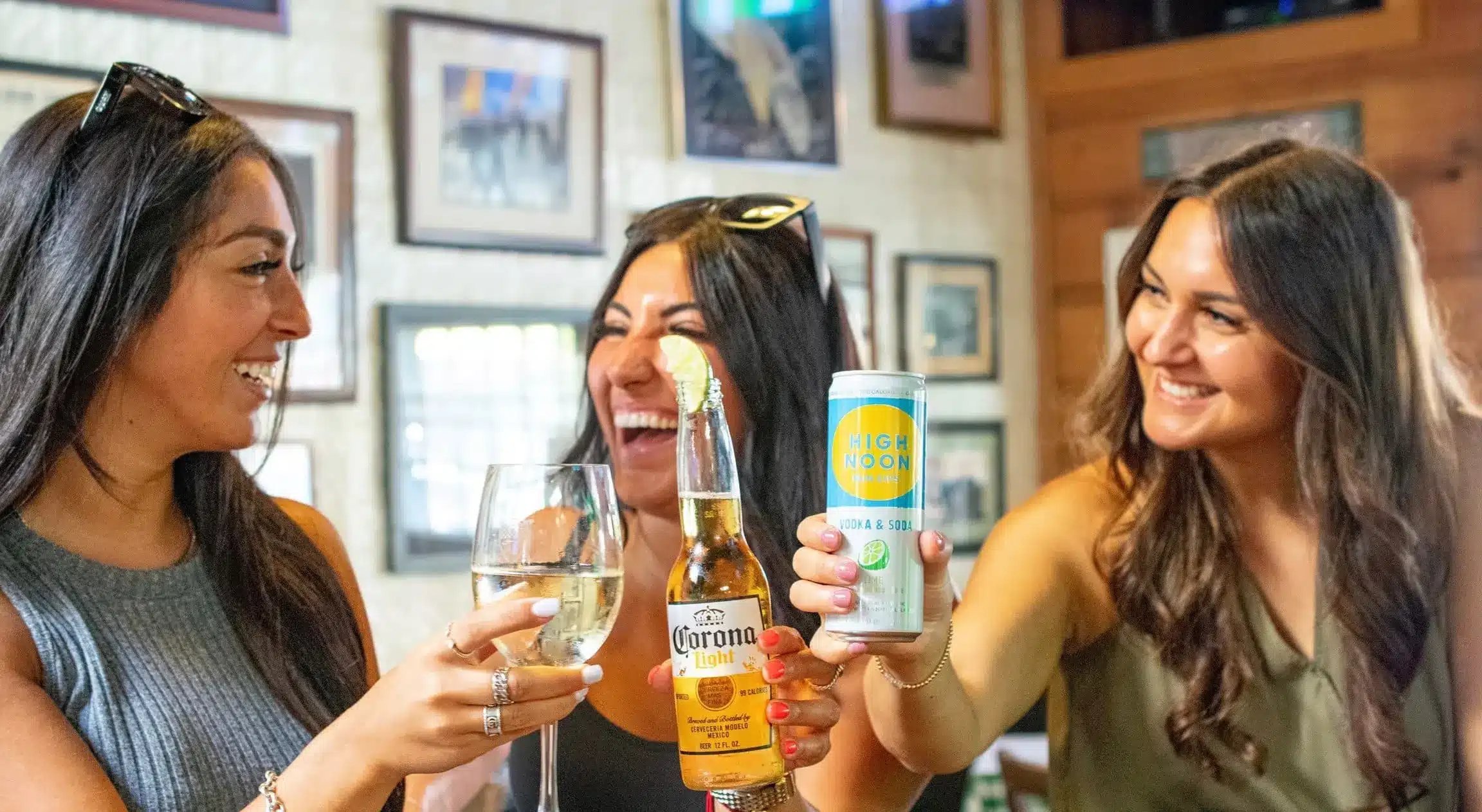 Three women enjoying drinks at happy hour at Finnegan's